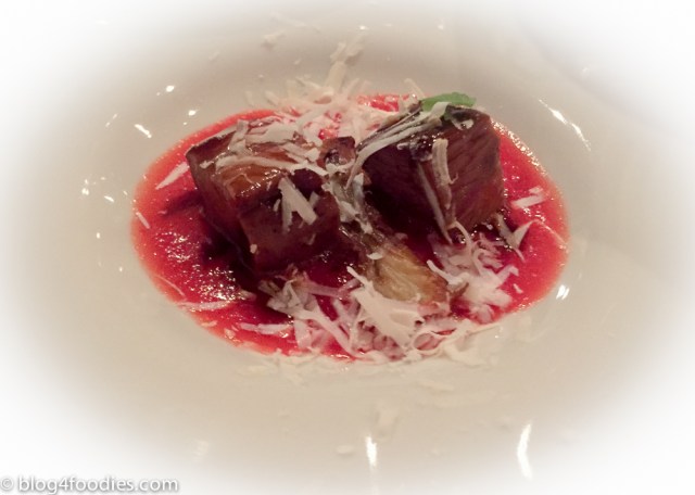 Lamb cube on tomato sauce, salty ricotta and basil