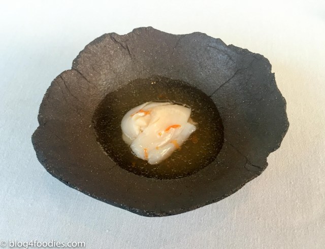 Tender raw slices of scallop with smoked cream, white current and heather